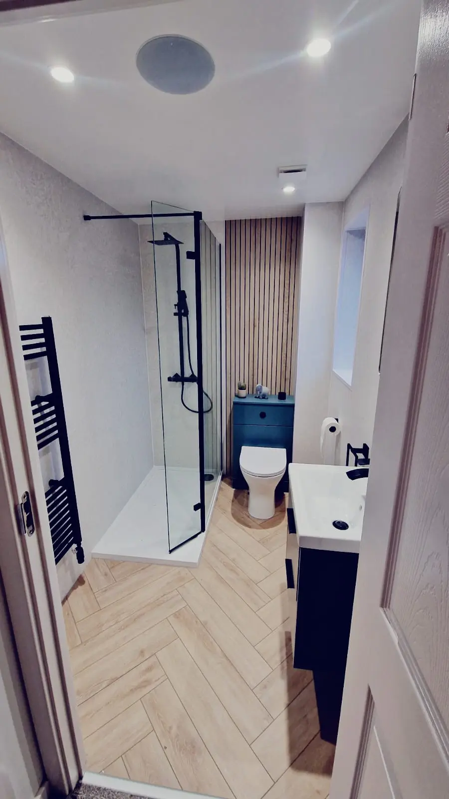 Blue vanity and black shower fittings