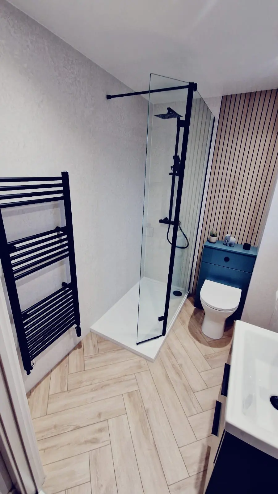 Blue vanity and black shower fittings